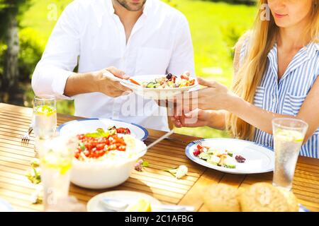 Repas de famille variété de plats italiens sur table en bois dans le jardin Banque D'Images