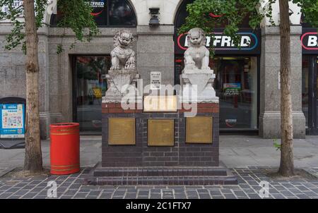 Statues du Lion gardien impérial dans Chinatown avec Betfred Paris shop en arrière-plan. Londres Banque D'Images