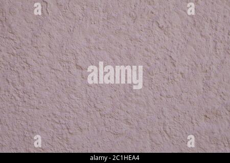 Texture d'un mur en plâtre avec stuc brut peint dans la couleur rose pâle, toile de fond pour le design. Banque D'Images