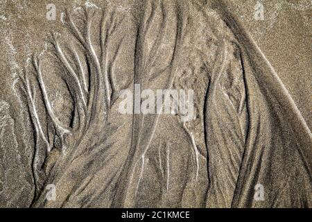 La texture du sable dessiné par les vagues Banque D'Images