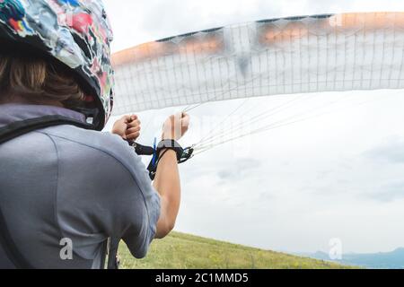 Gros plan le parapente ouvre son parachute avant de partir. Remplissage de l'aile du parachute avant le décollage Banque D'Images