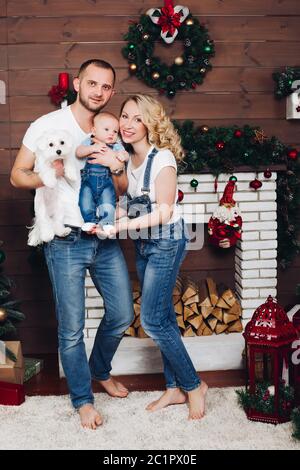 Positivity family posing ensemble près de cheminée et présente pour Noël Banque D'Images