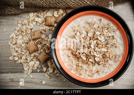 grains de cinq céréales avec garniture au chocolat, remplis de lait sur toile sur fond en bois Banque D'Images