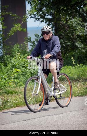 Un homme plus âgé probablement dans ses années 80 sur la piste cyclable de Little Bay Park, Whitestone, Queens, NYC. Banque D'Images