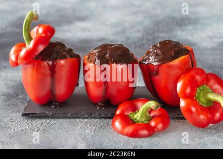 Poivrons rouges farcis avec de la sauce barbecue sur le conseil de pierre Banque D'Images