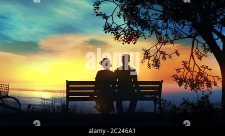 Silhouettes d'un couple assis sur un banc et regardant le coucher du soleil sur l'océan. Banque D'Images