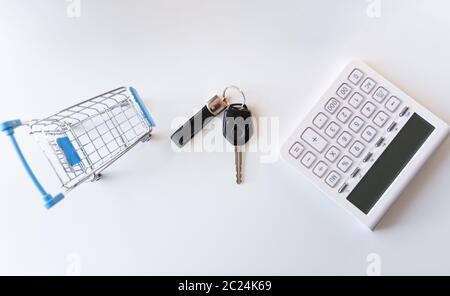 Achat de voiture concept. Vide Panier , les clés de voiture et une calculatrice sur tableau blanc Banque D'Images