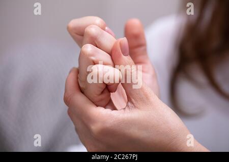 Close-up of Woman Cracking leurs doigts à la maison Banque D'Images