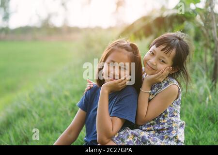 Joyeux petit enfant amies dans le champ vert Banque D'Images