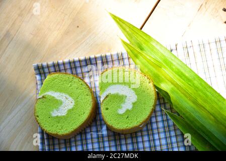 Crème de Pandan gâteau à la boulangerie-pâtisserie rouleau sur du tissu avec de la crème fraîche et la feuille de Pandan Banque D'Images