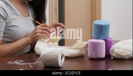 Femme triant avec crochet crochet et fil de crochet à la maison Banque D'Images