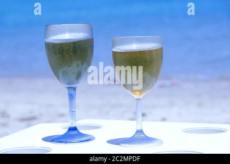 Deux verres de bière par mer. Bière fraîche dans des gobelets sur la table du complexe sur la côte océanique. Banque D'Images