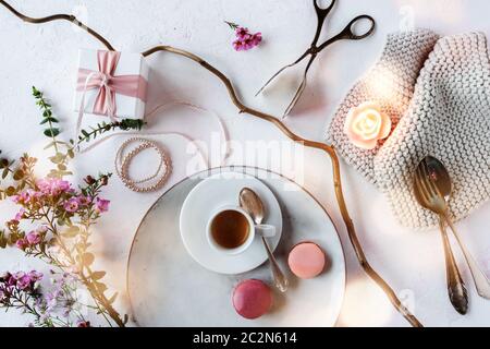 Décoration de fête des mères dans un style vintage lumineux avec des macarons colorés et une tasse d'espresso. Fleurs encore la vie avec le bokeh atmosphérique pour un petit déjeuner Banque D'Images