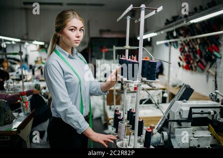 Créer des threads sur couturière noire machine surjeteuse, matériel à coudre. L'adaptation ou la couture sur garment factory Banque D'Images