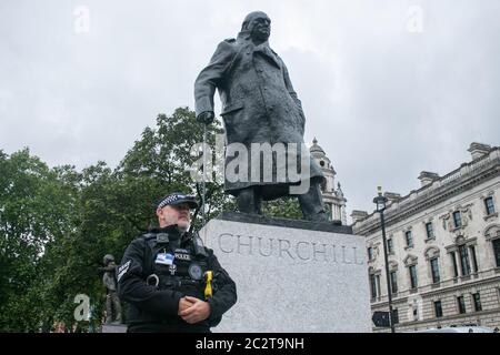 WESTMINSTER, LONDRES, ROYAUME-UNI. 18 juin 2020. Les policiers gardent la statue de l'ancien Premier ministre britannique de la guerre Sir Winston Churchill, qui a été découverte lors de la visite du président français Emmanuel Macron à Londres à l'occasion du 80e anniversaire de la diffusion « Appel » du général Charles de Gaulle pendant la Seconde Guerre mondiale. La statue a été couverte par les autorités après avoir été dédèle avec les mots « était raciste lors d'une manifestation Black Lives Matter. Crédit : amer ghazzal/Alay Live News Banque D'Images