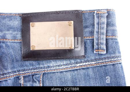 Close-up of blue jeans avec label Bronze. Isolated on white Banque D'Images