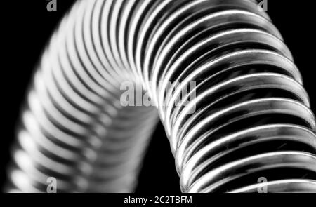 Close-up of coiled metal spring. Dans B/W Banque D'Images