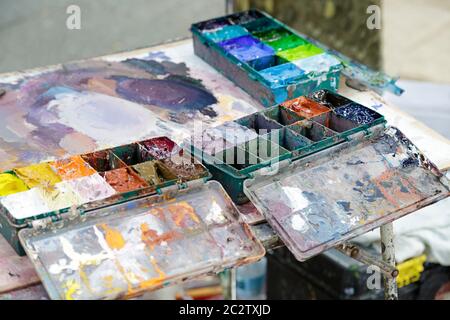 Palette d'art avec peintures à l'huile sur une table colorée de peinture Banque D'Images