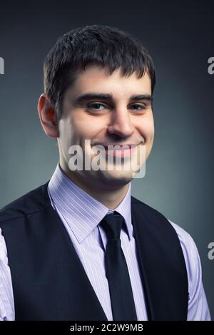 Smiling businessman vertical image studio shot Banque D'Images