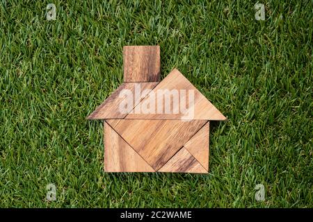 Portrait d'en-tête Tangram Accueil forme sur fond d'herbe verte artificielle Banque D'Images