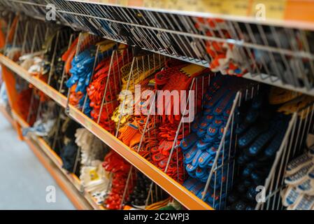 Assortiment de quincaillerie, étagère avec gants, personne. Choix de matériaux et d'outils de construction dans les ateliers de bricolage, rangées de produits sur des étagères Banque D'Images