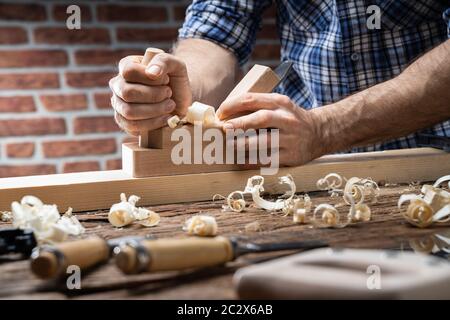 Carpenter À L'Aide De Jack-Plane Et De Divers Outils De Toolkit Banque D'Images