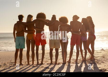 Groupe multiethnique de hommes et de femmes se tenant sur la plage Banque D'Images