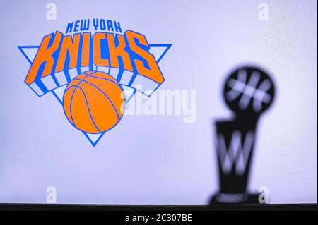 NEW YORK, Etats-Unis, 18 JUIN 2020 : New York Knicks Basketball club sur écran blanc. Silhouette du trophée NBA en premier plan. Banque D'Images