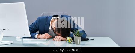 Photo de fatigué Businessman Sleeping In Office Banque D'Images