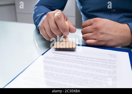 Close-up of Businessman Hand en utilisant Stamper sur le document Banque D'Images