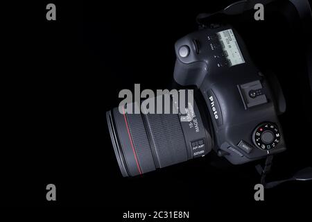 Appareil photo numérique professionnel avec objectif zoom et lanière en cuir sur fond noir avec espace de copie. Vue de dessus. Rendu 3d réaliste Banque D'Images