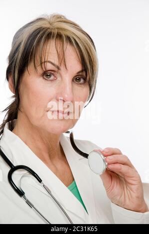 Portrait latéral de la tête et de l'épaule d'un médecin de sexe féminin portant un manteau blanc et un stéthoscope isolé sur fond blanc regardant sérieusement le CA Banque D'Images