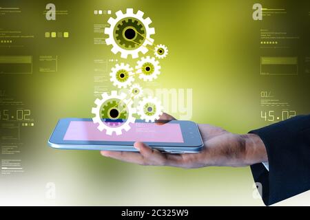 Tablette numérique dans la main et pignons Banque D'Images