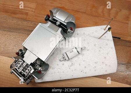 Processus d'assemblage d'un modèle de voiture à grande échelle. Moteur, système d'échappement, suspension et freins collés et peints Banque D'Images
