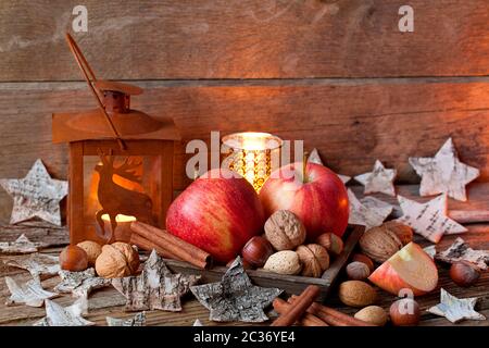 Noël toujours la vie dans un style rustique avec lanterne, pommes et noix Banque D'Images