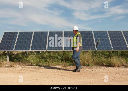 Manor Texas USA, 2012: White male utilise une caméra d'imagerie thermique pour effectuer le contrôle de la qualité et vérifier les mauvaises cellules à la ferme solaire de Webberville, le plus grand projet solaire actif de tout service public d'énergie dans le pays. Il dispose de plus de 127 000 modules et peut générer plus de 61 millions de kWh d'électricité, Texas - 2012. ©MKC / Daemmrich photos Banque D'Images