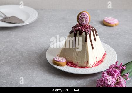 Arrière-plan de l'alimentation de Pâques. Caillé traditionnel gâteau de Pâques avec des fleurs de printemps crocus sur le fond clair. Cottage de pâques fromage  + dessert Banque D'Images