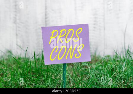 Note d'écriture montrant les cons. Pros Concept d'affaires pour les avantages et les inconvénients observés lors de l'examen d'un produit papier ordinaire attaché à bâton et Banque D'Images