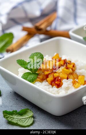 Porridge de riz au lait d'amande et pommes caramélisées. Banque D'Images