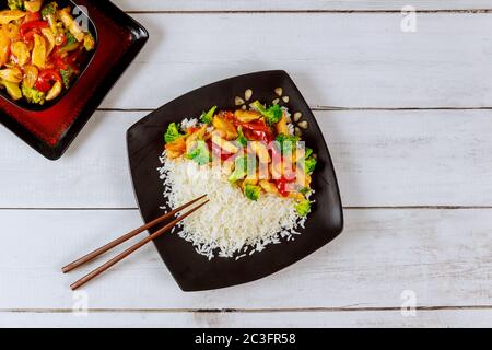 Brasser la viande asiatique, les légumes avec du riz blanc et un bâton de hache. Banque D'Images