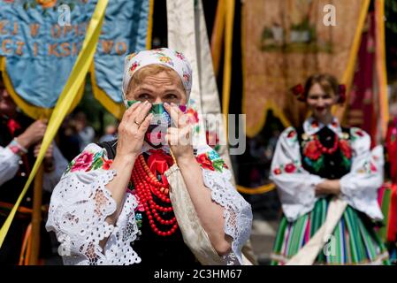 Lowicz, 11 juin 2020: Portrait d'une femme vêtue de Lowicz en costume folklorique national polonais et masque protecteur du visage pendant la procession de Corpus Christi Banque D'Images