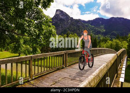 La femme dans un masque de protection fait un vélo sur le pont au-dessus de la rivière - illustration 3d Banque D'Images