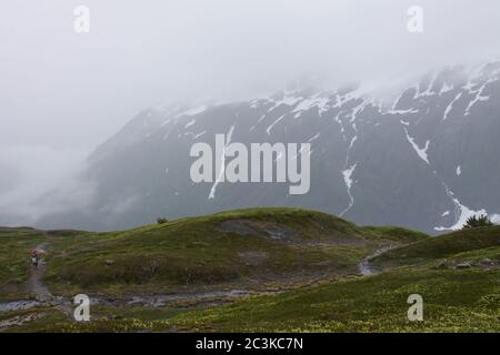 Randonneurs sur le sentier de sortie du glacier en Alaska, lors d'une journée de brouillard entourée de montagnes Banque D'Images