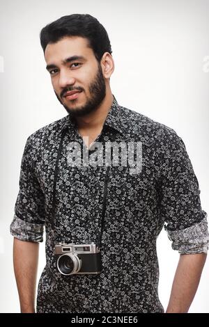 Gros plan portrait d'un photographe avec un appareil photo vintage portant une chemise noire décontractée isolée sur fond blanc Banque D'Images