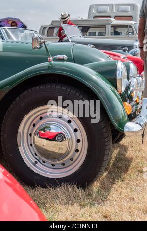 Le reflet d'une voiture Morgan classique se reflète dans le chapeau de moyeu d'un Morgan plus 4 classique CARE Angleterre Banque D'Images