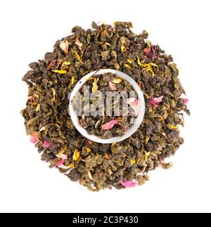 Nouez le thé Guan Yin avec les pétales de lilas, d'hibiscus et de tournesol, isolés sur fond blanc. Thé vert biologique. Vue de dessus. Gros plan. Banque D'Images