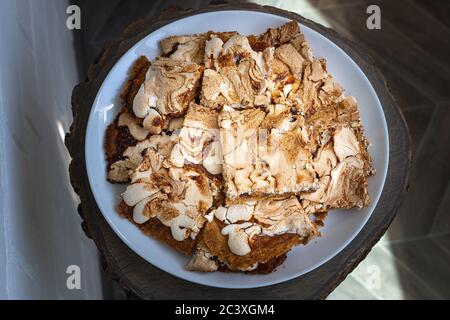 Vue de dessus des morceaux oblongs de gâteau maison à crumble avec confiture de fraise couverte de meringue servi sur une table en bois. Streuselkuchen Cake, gros plan Banque D'Images