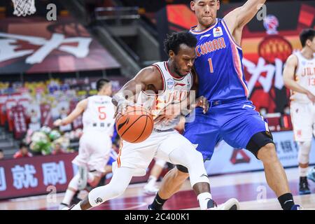 Sean Hill Jr., joueur américain de basket-ball, de Jilin Northeast Tigers, à gauche, garde le ballon pendant un match à la première étape de la reprise de l'Association chinoise de basket-ball (CBA) contre les baleines bleues du Sichuan, ville de Dongguan, province de Guangdong, dans le sud de la Chine, le 21 juin 2020. Jilin Northeast Tigers a battu Sichuan Blue Whales avec 97-85. La ligue de basket-ball chinoise a repris après un arrêt de presque cinq mois, avec moins de joueurs étrangers et aucun fan dans les tribunes. L'ABC a été suspendue le 24 janvier, une semaine avant son retour prévu à la suite d'une pause printanière à la fin du regula Banque D'Images