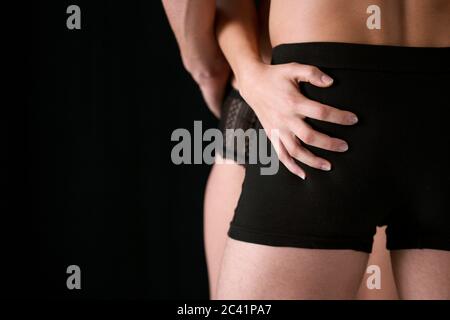 Jeune couple qui s'enserre, mains touchant les fesses Banque D'Images