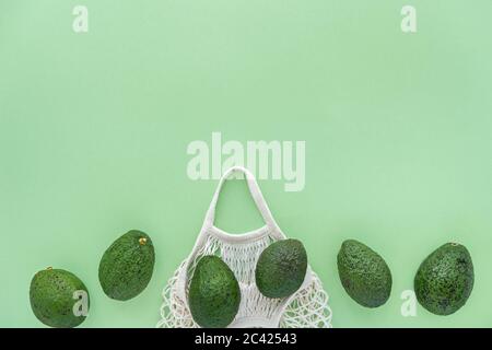 Sac de coton en maille éco d'épicerie avec avocats.Vegetarisme. Concept de shopping et de mode de vie écologique. Espace pour le texte. Banque D'Images